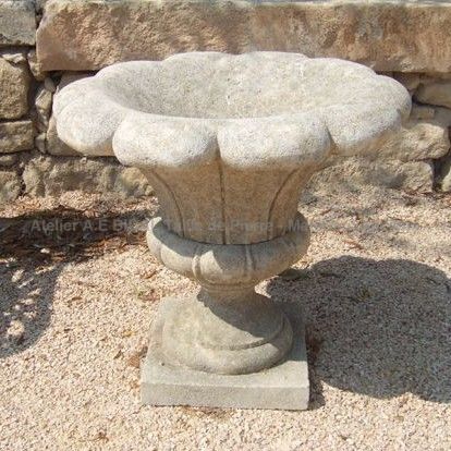 Natural limestone vase carved in the shape of a flower