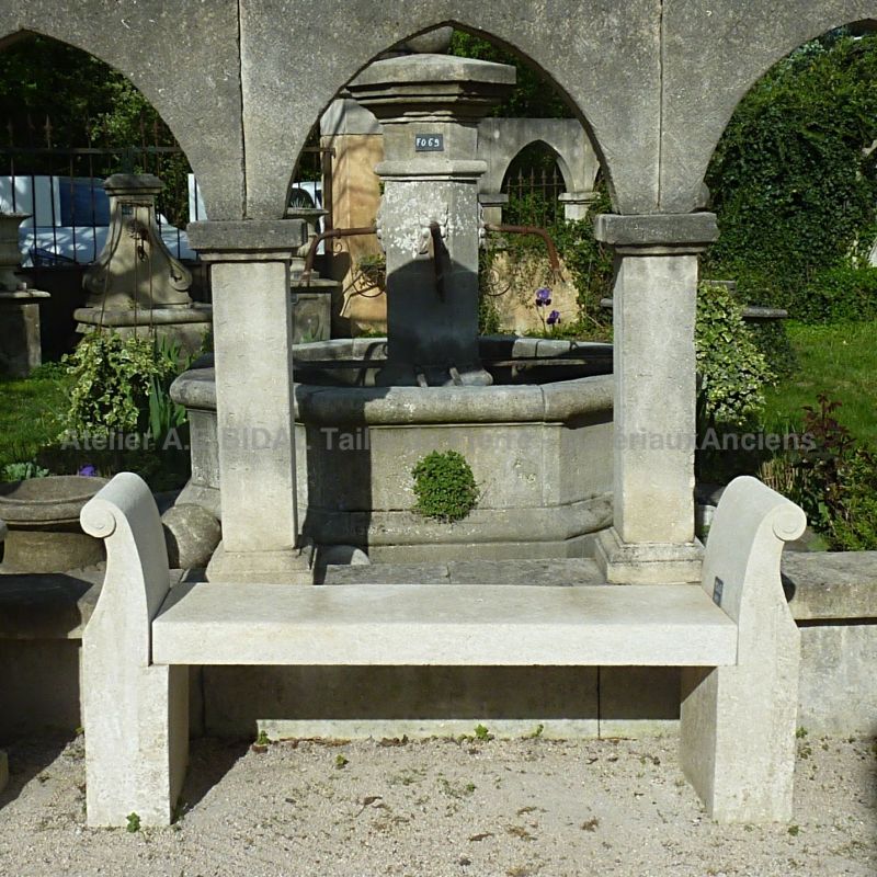 Long stone bench with armrests by the stone-cutting atelier Alain Bidal in Provence.