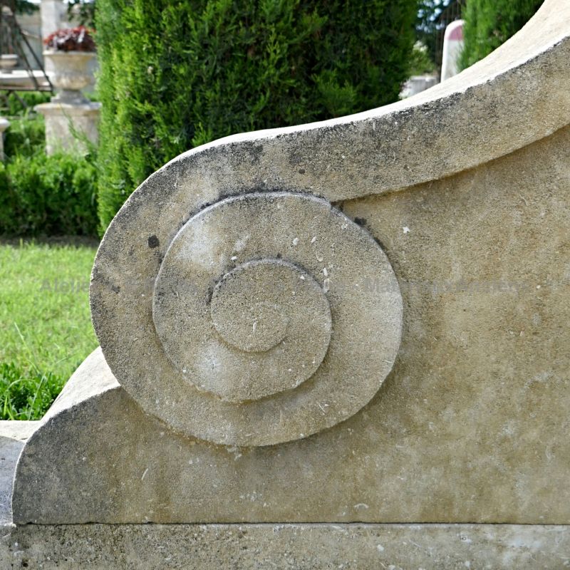 Detail of a hand carved stone arabesque on our tall wall fountain in French limestone.