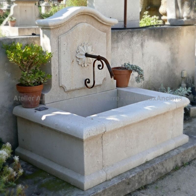 Outdoor fountain in stone made by the craft firm Bidal, stone masons in Provence.