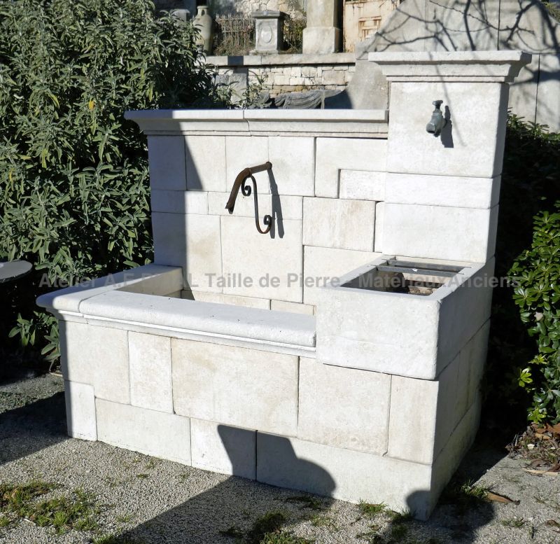Provencal fountain hand carved in a white limestone - A wall fountain signed Atelier Alain Bidal.