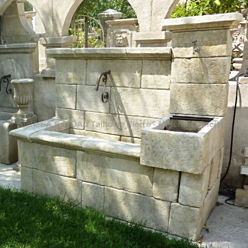 Large decorative Provence fountain carved in natural stone by the stonecutter Alain BIDAL.